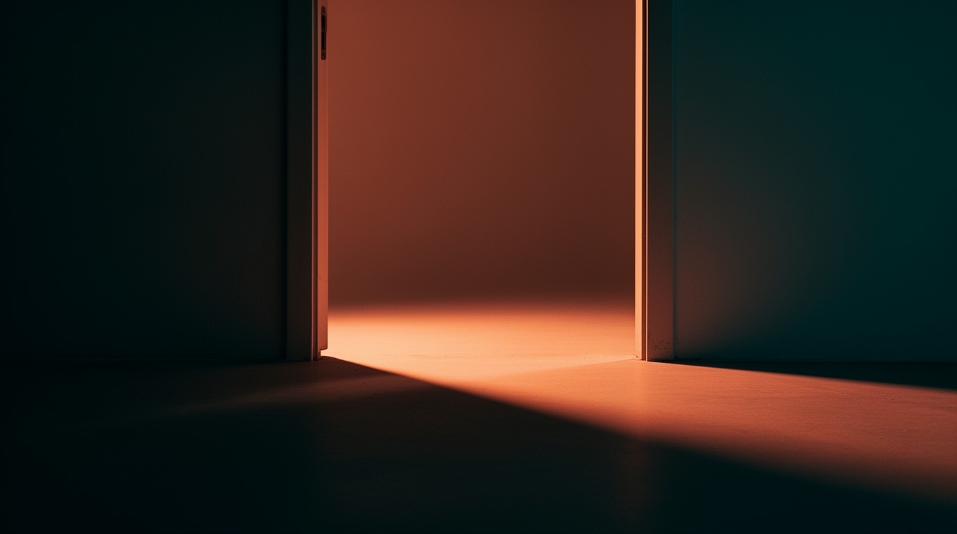 An open doorway threshold with warm light spilling across the floor